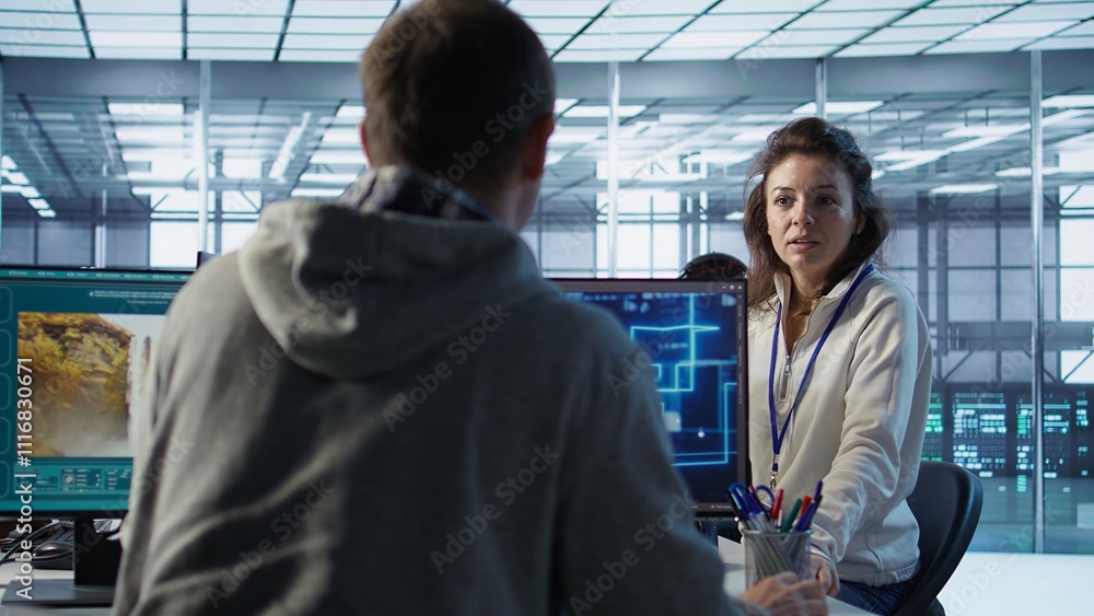 Poster engineer in server room chitchatting with colleague while making ai generating videos software. it e
