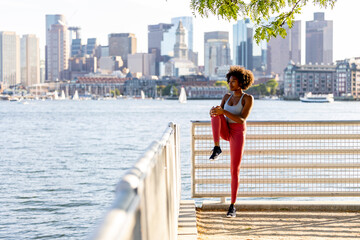 Young healthy black woman stretch leg