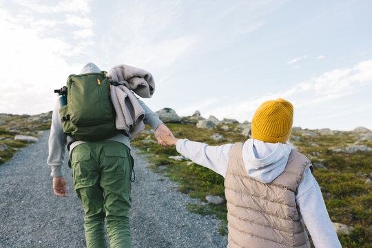 Father with a daughter hiking in the mountains