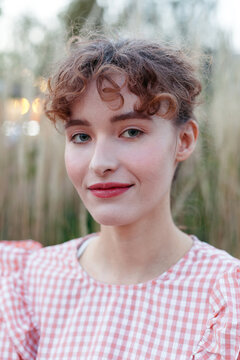 A young woman with curly hair evening closeup