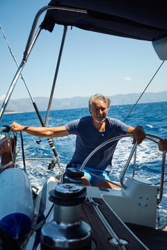 Cheerful man enjoys sailing