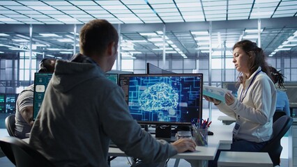Fototapeta premium Manager conducting inspection in office, checking progress done by IT worker building AI diffusion model app. Team leader supervising engineer making software producing AI generated videos, camera B