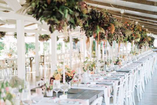 Detailed view of a long, elegantly set dining table.