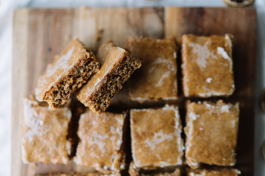 Moist brown squares with white glaze on wooden board.
