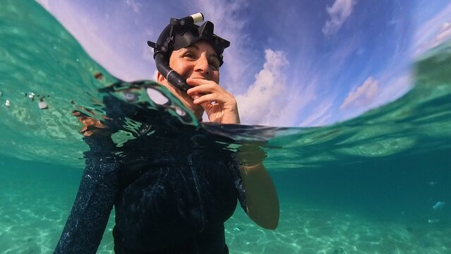 Diver Emerging from Turquoise Water in Maldives. Ugc, pov