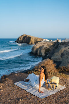 Woman relaxing by cliffside