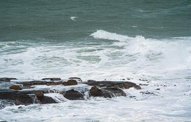 Waves crashing over rocks ocean rough east coast new zealand oamaru