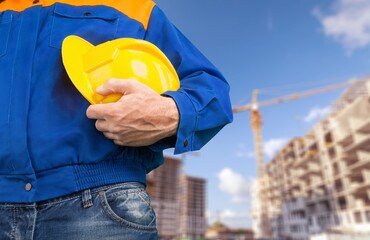 Safety workwear hold safety helmet at construction