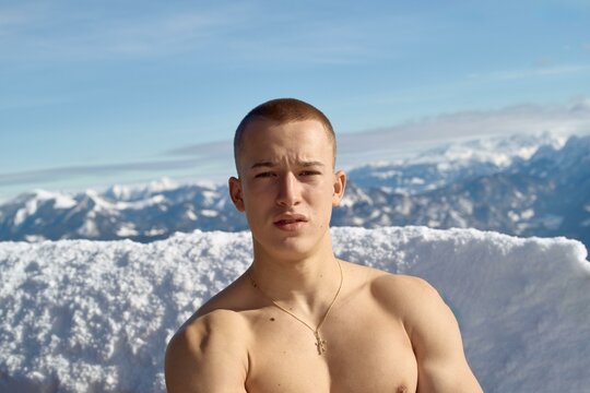 Confident young man on snowy peak