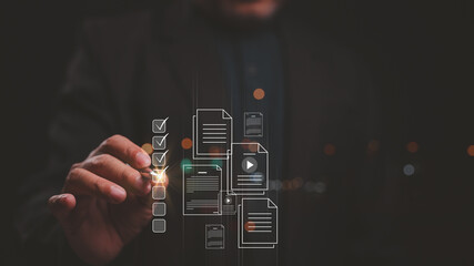 Business professional interacts with digital documents and checklist interface, symbolizing modern data management, organization, and efficiency in high-tech workspace
