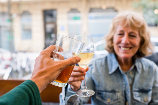 POV drink toast with smiling senior woman