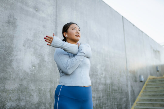 A woman does exercises outdoors