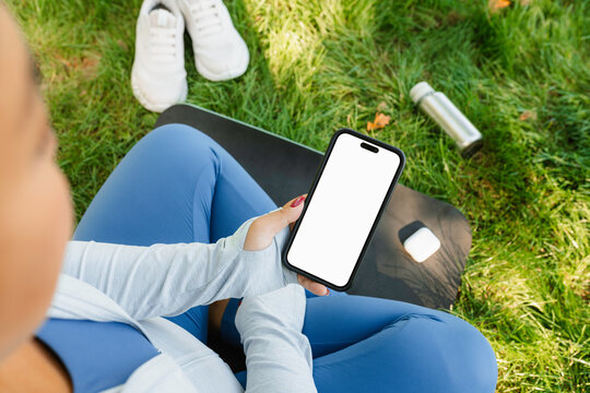 A woman uses a mobile phone during sports