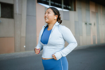 A woman is jogging outdoors
