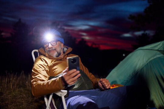 Relaxed camper holding his phone