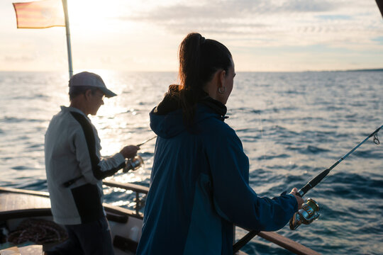 Adult daughter and father fishing together