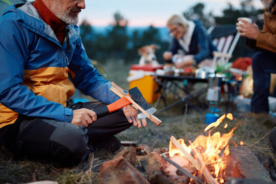 Man makes a bonfire at the campsite