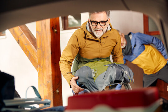 Men prepare their stuff for a roadtrip