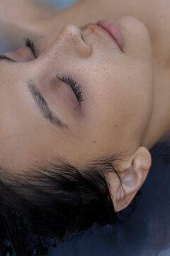 CloseUp portrait of Woman with freckles and Eyes Closed 