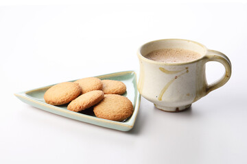 Hot masala tea masala chai and biscuit, Kerala India. Evening tea with refreshing Indian blend of black tea with milk and spices
