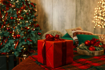 Decorated Christmas tree in the room. Near different box with gifts on New year