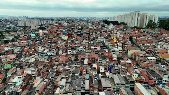 4K aerial footage showcasing a sprawling favela in Osasco, Brazil, highlighting urban density and striking contrasts with nearby modern buildings
