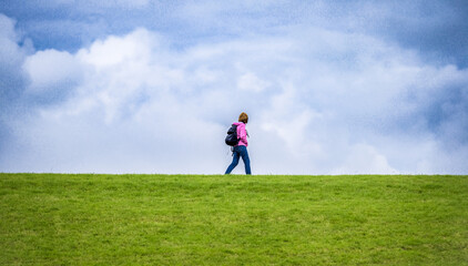 Hiking. Travel and tourism. The Hiking. Woman with backpacks. Woman with backpack at field.