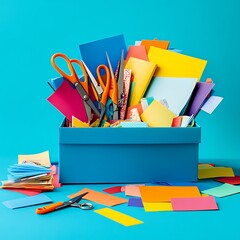 Fototapeta premium Colorful craft supplies overflowing from a blue box on a blue background.
