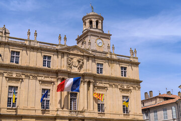 Fototapeta premium Town Hall of Arles - A close-up and low-angle view of the historic Town Hall of Arles at the main town square, place de la Republique, on a sunny Spring day. Arles, Southern France.