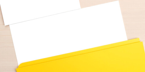 Open file folder with blank space for text on wooden desk, ideal for templates. vibrant yellow folder adds cheerful touch to your workspace