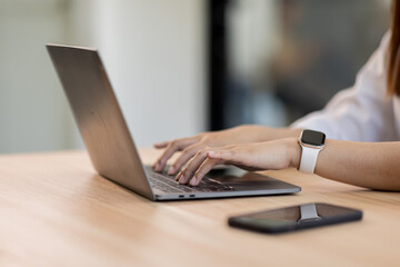 Close up of business asian woman hand typing on laptop computer, searching and surfing the internet...