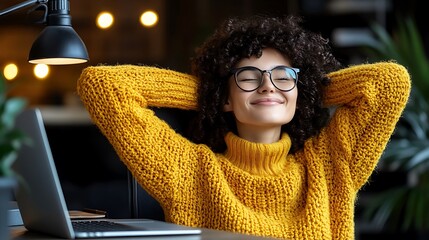 A man ending his workday by closing his laptop and stretching in his home office.