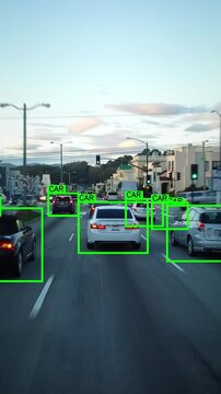 Autonomous car driving through a San Francisco neighborhood. Computer vision with object detection system that creates boxes to recognize the different objects. Artificial intelligence technology.