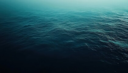 Obraz premium A serene view of calm ocean waves under soft lighting.