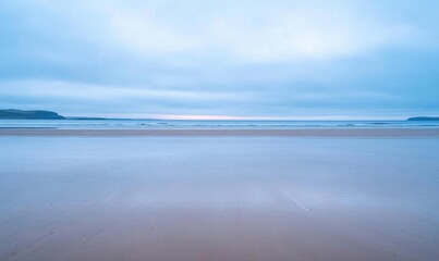 A serene beach scene at dawn with soft colors and gentle waves.