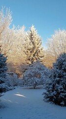 Obraz premium A serene winter landscape with snow-covered trees and clear blue sky.