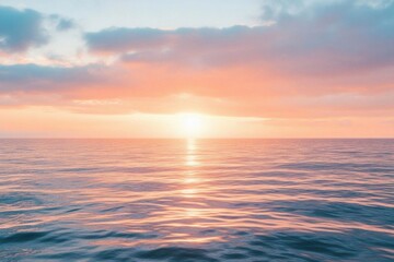 Obraz premium A serene sunset over calm ocean waters, creating a tranquil atmosphere.