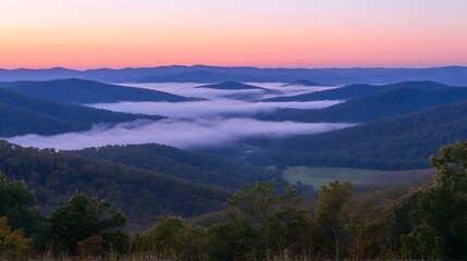 Obraz premium Serene sunrise over misty mountain valley.