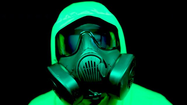 Person in Full Face Respirator Tilting Head Under Cyan Light, Robotic Movement Study with Protection Mask, Abstract Android Performance