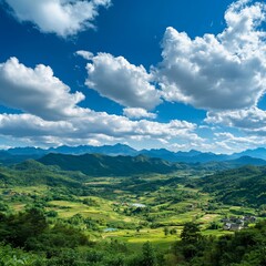 Obraz premium Vast Blue Sky Over Green Mountains and Charming Villages