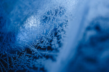 Frost icy flowers on a winter car