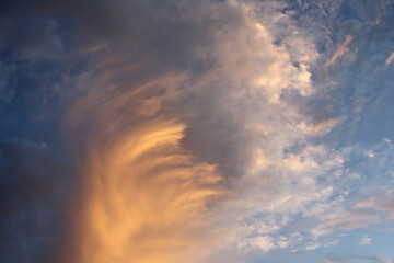 Dramatic sky at sunset with golden stormy clouds abstract textured background
