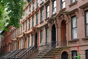 Long row of old brownstone buildings in New York City
