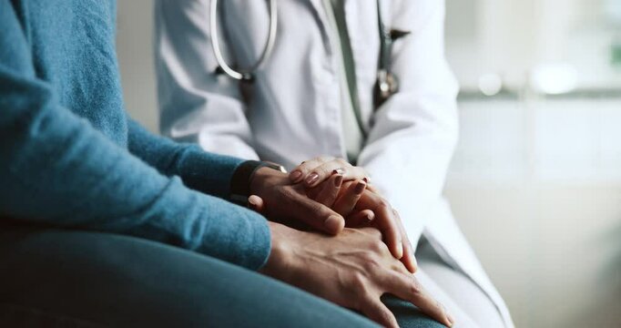 Doctor, patient and holding hands with empathy and support for cancer news and diagnosis. Healthcare, consultation and helping with kindness and advice for chemotherapy and wellness at clinic