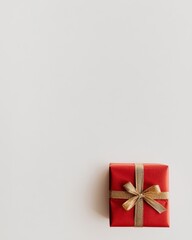A beautifully wrapped Christmas gift displayed against a pristine white background. The box is elegantly adorned with festive red wrapping paper and a golden ribbon tied in a perfect bow.