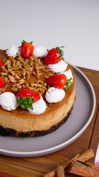 Vertical video, Freshly Homemade Mexican Chocoflan, Impossible Cake, Flan napolitano, a Mexican dessert with strawberries, nuts and whipped cream on top