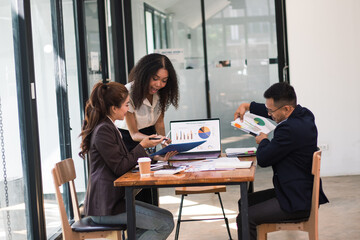 Asian businessmen come together to analyze market data.