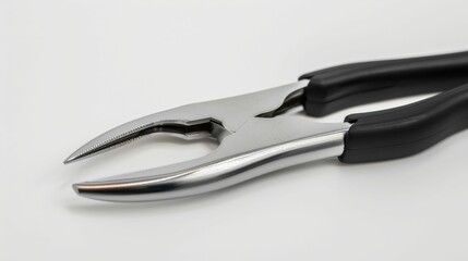 Obraz premium A close-up view of a pair of shiny, metallic pliers with black rubber grips, ideal for gripping and manipulating objects.