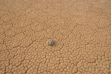Moving rocks in the dry lake bed at The Racetrack at Death Valley National Park, California