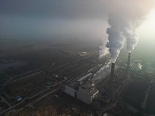 Thermal power plant. Active smoke from pipes and cooling towers. The view from the drone.